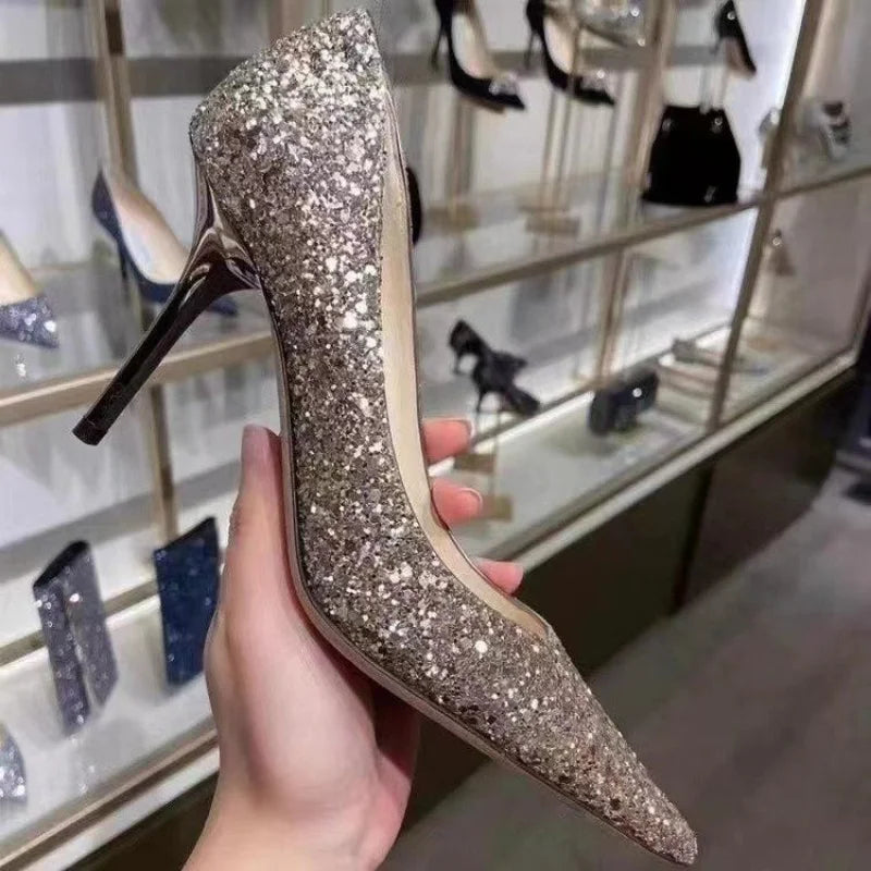 Gold glitter slim heel dress shoes with a pointed toe for a wedding.