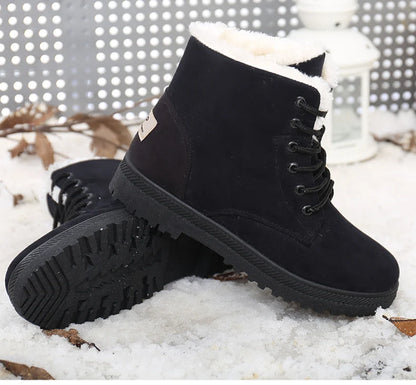 Black suede ankle snow boots with white faux fur lining, black laces, and ridged rubber soles.