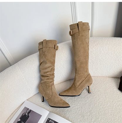 Khaki suede pointed-toe high heel boots with a buckle strap and slouchy shaft.