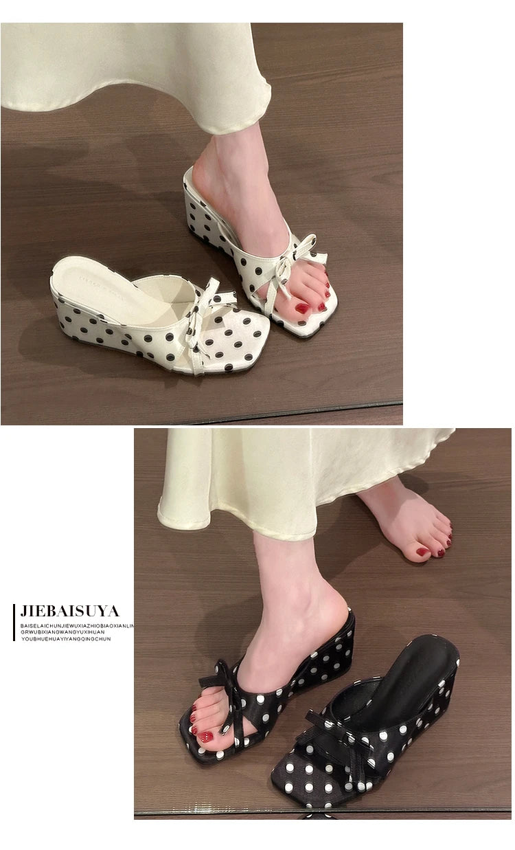 White and black polka dot wedge heel sandals with bow details and cushioned insoles for casual wear.
