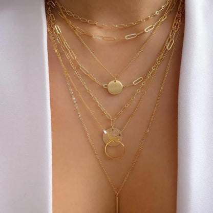 Layered necklace set featuring multiple chains and pendant charms with rhinestones