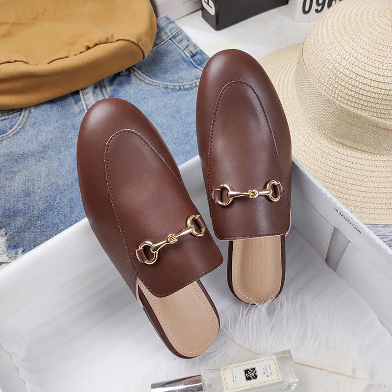 Brown leather slip-on shoes featuring a gold chain detail for comfortable all-day wear.