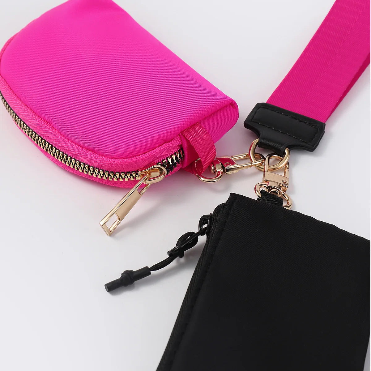 Hot pink and black nylon dual pouch with zip closure and adjustable strap for everyday waterproof wristlet wallet use.