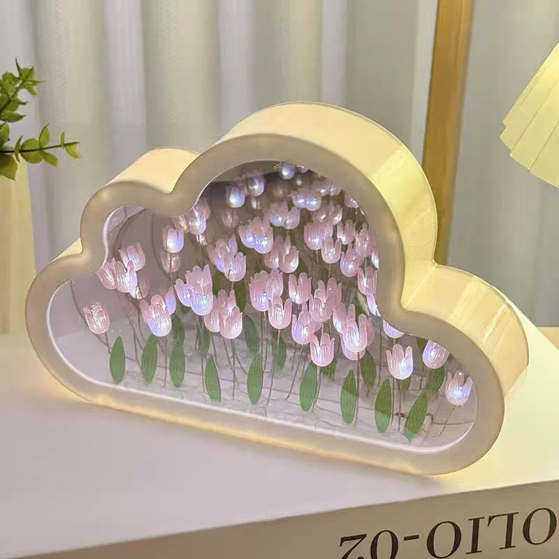 Cloud-shaped mirror panel with pink LED tulips for desk decor, creating a soft ambient glow.