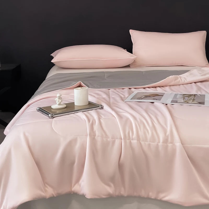 Soft pink and grey reversible bedding & bath comforter designed to keep hot sleepers cool throughout the night.