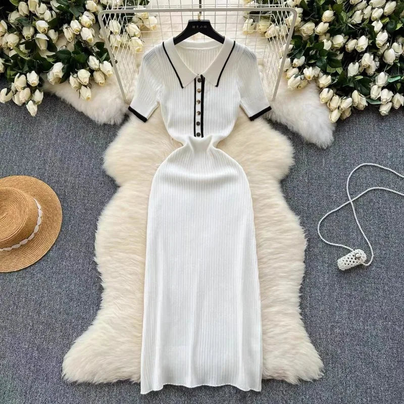 White ribbed knit fitted dress with black polo collar and buttons for casual outings.