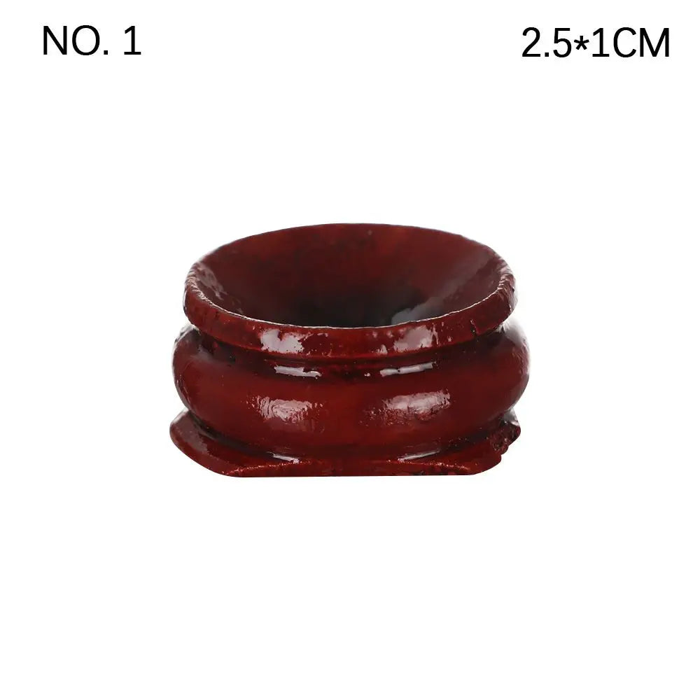 Dark reddish-brown wooden crystal ball stand with a rounded, stepped base and a concave top depression.