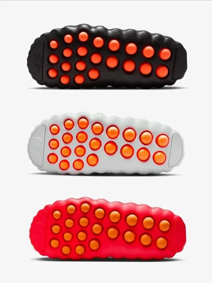 Black, white, and red EVA sandals with orange non-slip massage soles for daily wear.