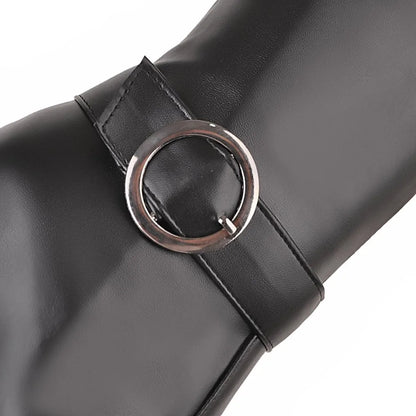 Black faux leather tall boot detail, featuring a strap secured by a round metallic buckle.