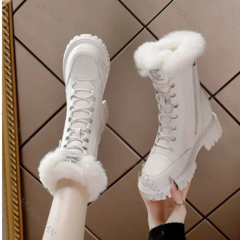 White lace-up snow boots with chunky platform soles and white faux fur trim around the ankle.