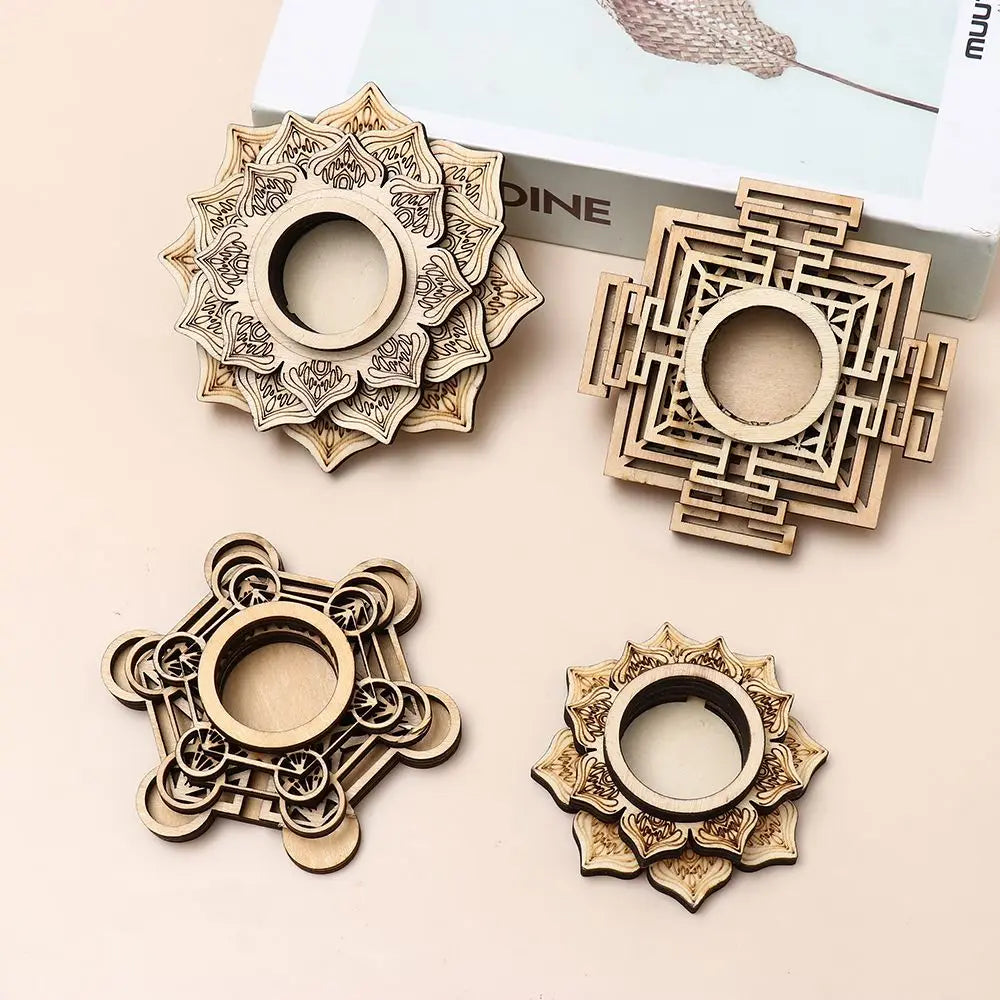 Four light wood laser-cut crystal ball stands with lotus, square, and geometric mandala patterns.