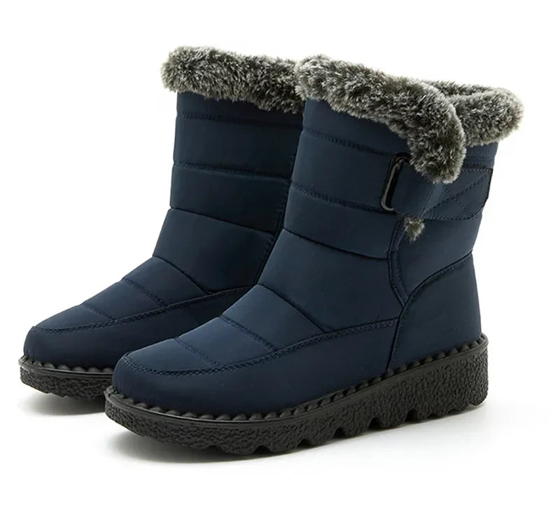 Navy blue quilted winter snow boots with plush faux fur trim, side buckle, and thick black treaded soles.