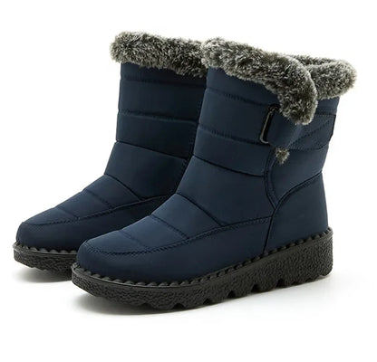 Navy blue quilted winter snow boots with plush faux fur trim, side buckle, and thick black treaded soles.