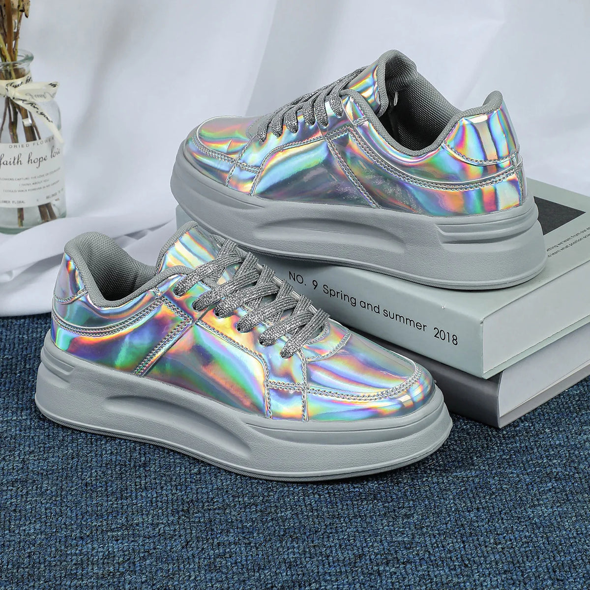 Holographic metallic thick-sole sneakers with grey laces, lining, and platform soles.