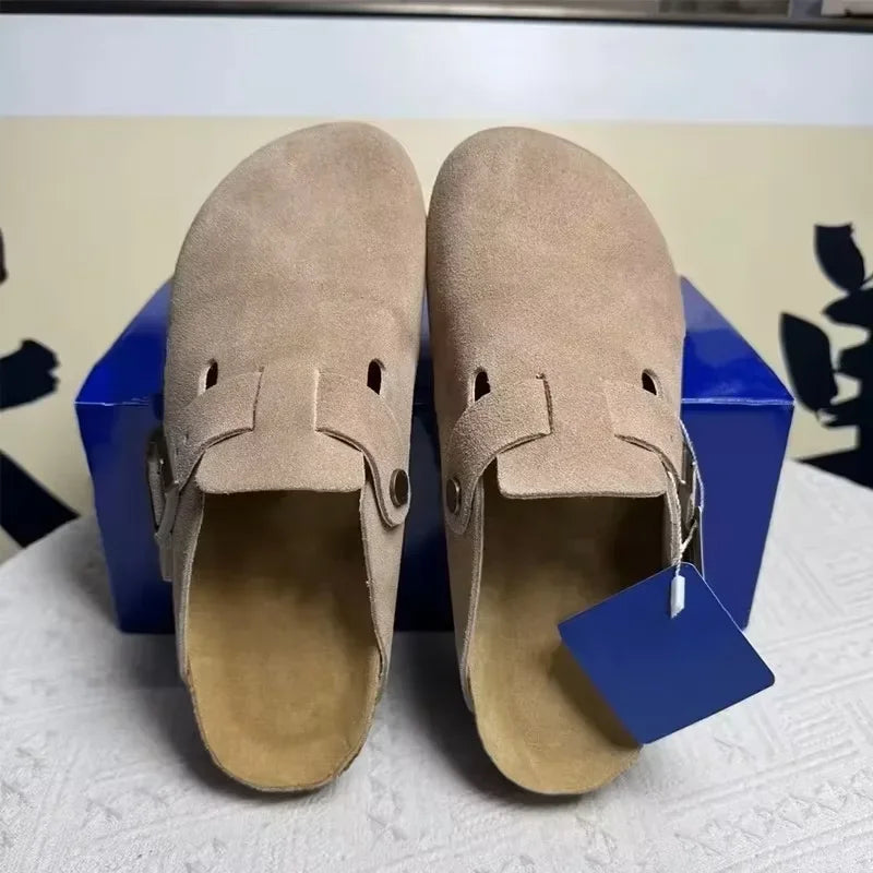 Beige suede slip-on mules with a side buckle and non-slip sole, ideal for casual everyday wear.
