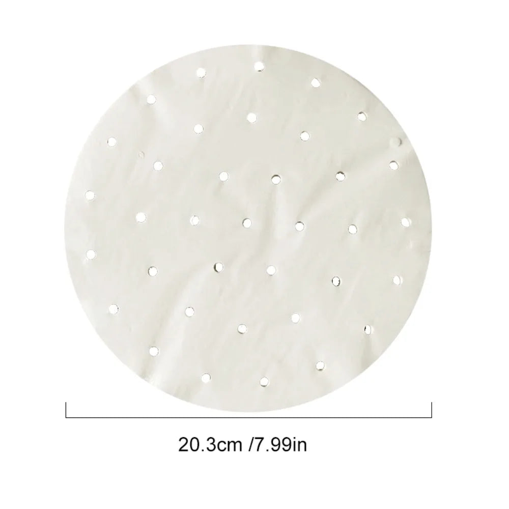 Round white parchment paper steamer liner, 20.3 cm in diameter, perforated with evenly spaced holes.