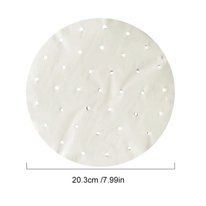 Round white parchment paper steamer liner, 20.3 cm in diameter, perforated with evenly spaced holes.