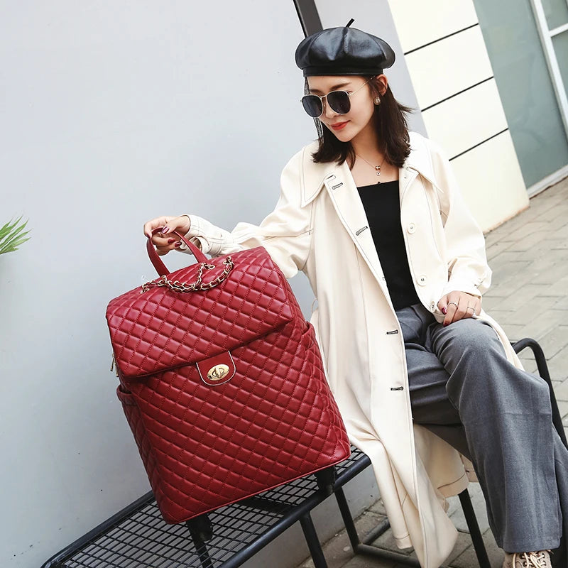 Red quilted PU leather retro rolling suitcase with a front flap, gold turn-lock, and chain handle.