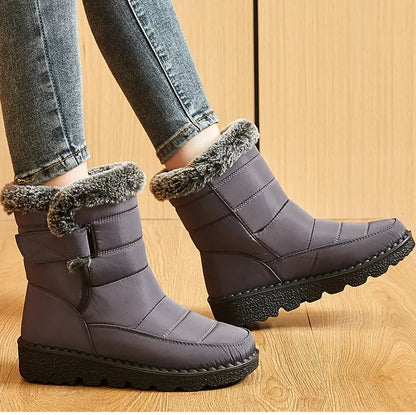 Gray quilted ankle snow boots with faux fur trim, side velcro straps, and textured black rubber soles.