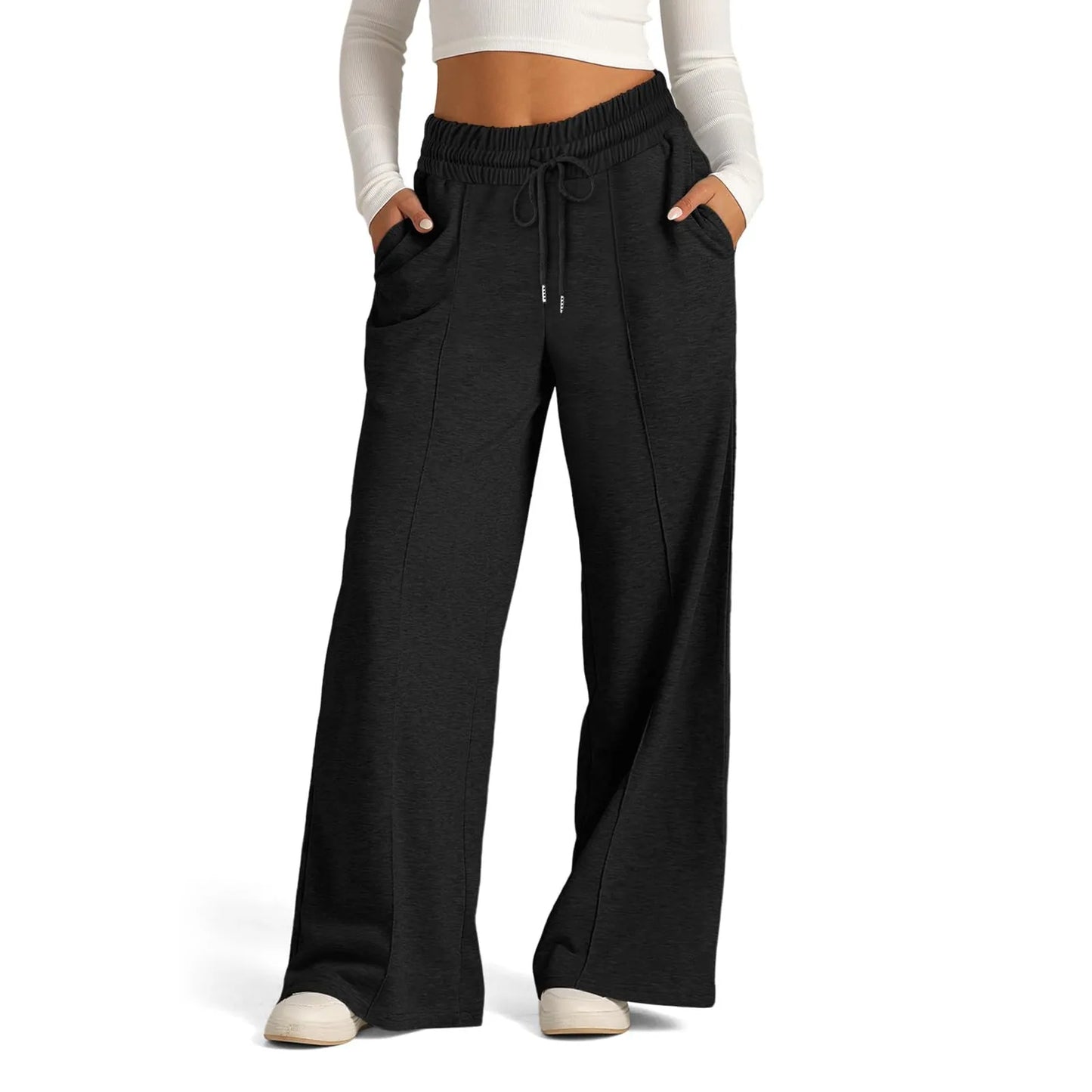 Black fleece-lined high waist flowy pants with a drawstring, worn for lounging in cold weather.