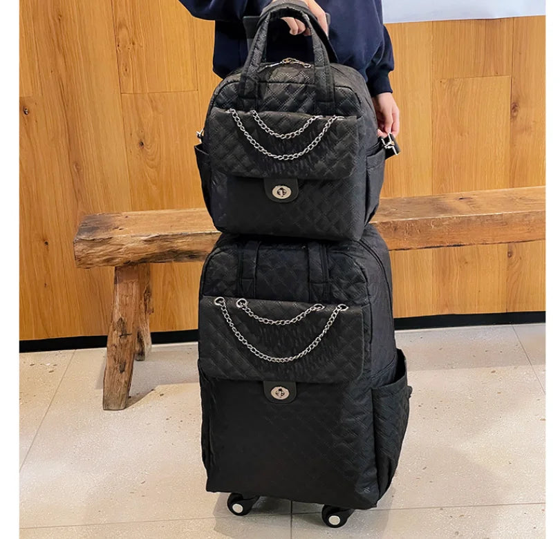 Black quilted nylon rolling travel bag and matching handbag set with silver chain details and twist-lock front pockets.