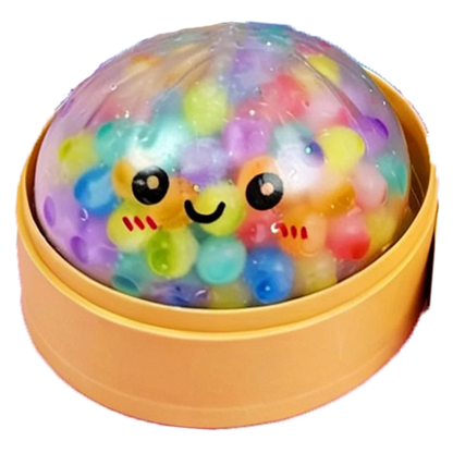 Clear, soft foam dumpling fidget toy with colorful beads and a smiling face in a yellow steamer for sensory play.