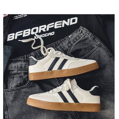 White canvas sneakers with black stripes and gum soles. Breathable casual training shoes for daily athletic activity.