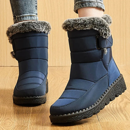 Navy blue waterproof winter boots with quilted shafts, faux fur trim, side strap, and black platform soles.