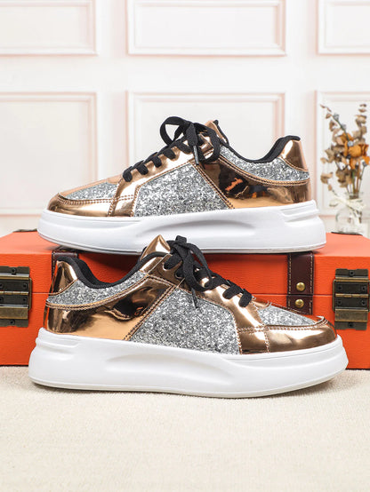 Rose gold and silver glitter lace-up sneakers with thick white soles.