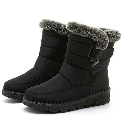 Black waterproof winter boots with quilted shafts, faux fur trim, side buckle, and textured rubber platform soles.