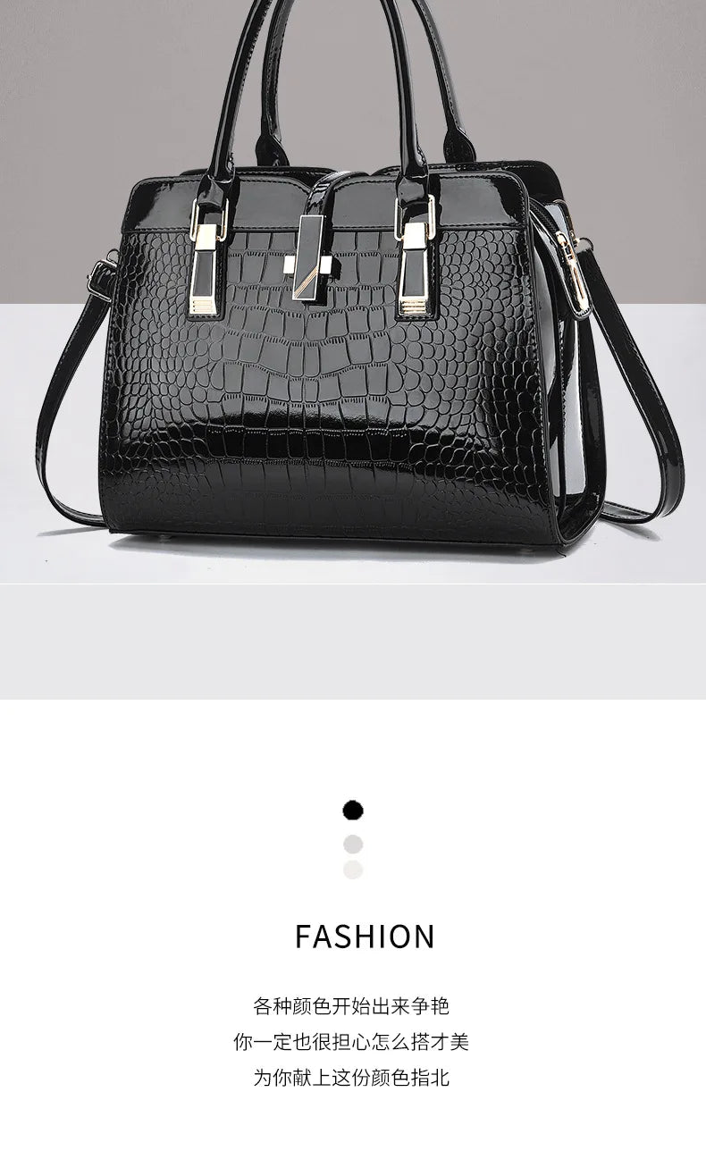 Black patent leather crocodile-pattern tote bag with dual top handles and gold-tone hardware.