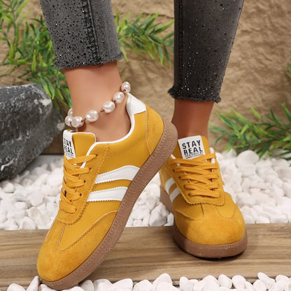 Yellow suede and leather sneakers with white stripes and gum soles, these slip-on shoes are comfortable for daily wear.