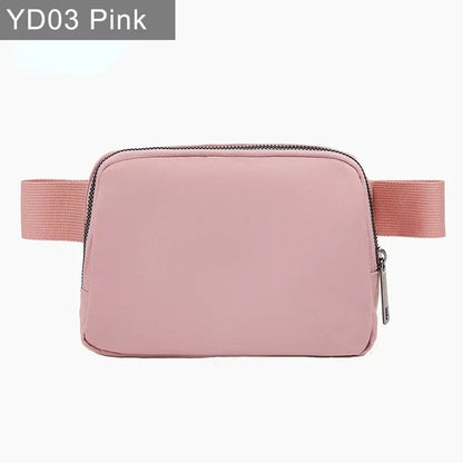 Pink waterproof crossbody bag with zip closure and adjustable strap for running and yoga.