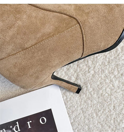 Tan suede high heel boot with a thin stiletto heel and visible stitching details.