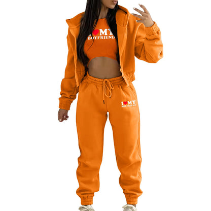 Orange ribbed knit sweater set with hooded jacket and high waist joggers for a cozy casual look.