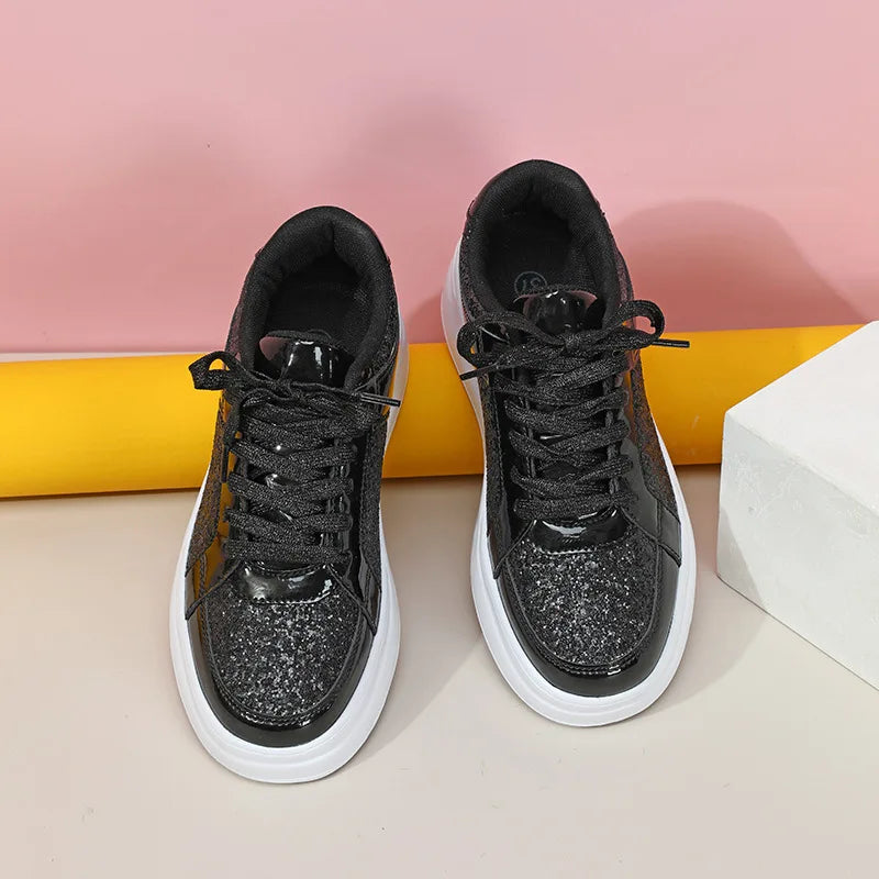 Black sequin casual sneakers with thick white soles and black laces.