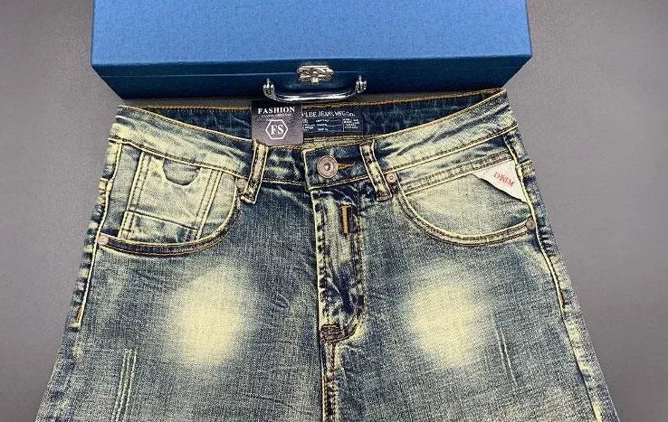 Blue acid wash tapered jeans with stretchy denim material for daily comfort.