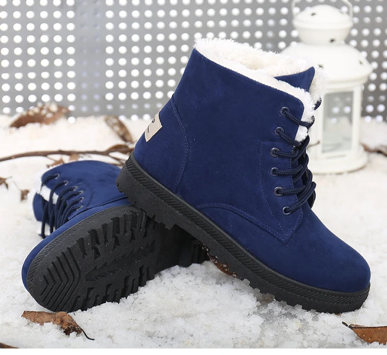 Blue suede ankle boots with white fur lining, lace-up front, and black treaded rubber soles.