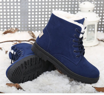 Blue suede ankle boots with white fur lining, lace-up front, and black treaded rubber soles.