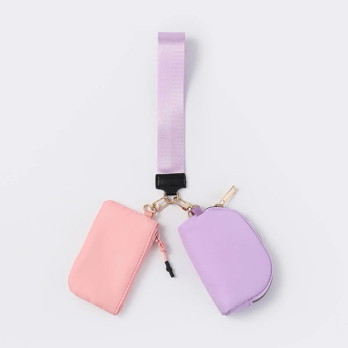 Pink and purple nylon dual pouch with a wristlet strap, zip closure, and gold hardware for organized daily carry.