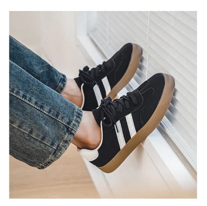 Black canvas sneakers with white stripes and brown soles, a breathable casual training shoe for daily wear.