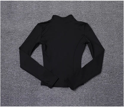 Black long sleeve polyester sport jacket with a fitted, sculpting design for gym training and yoga.