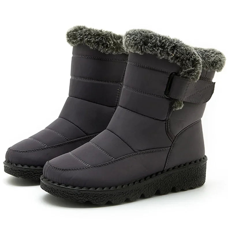 Dark grey quilted winter snow boots with plush faux fur trim, side strap, and black platform soles.