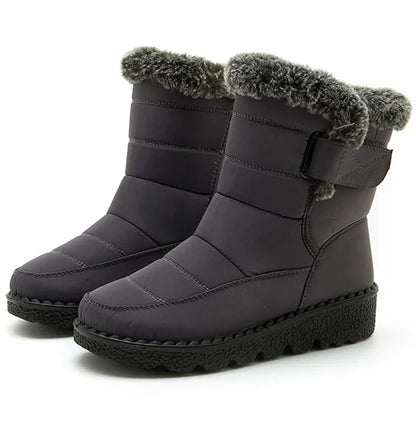 Dark grey quilted winter snow boots with plush faux fur trim, side strap, and black platform soles.