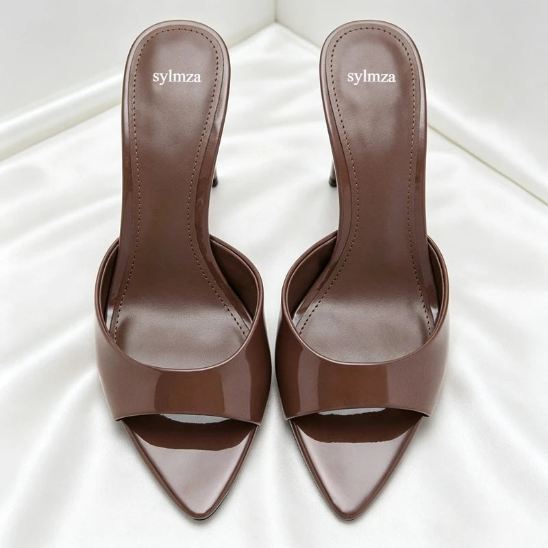 Brown patent leather slip-on open toe sandals with thin heels for a party.