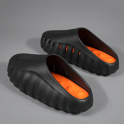 Black and orange cushioned platform sandals with a textured, slip-on design for comfortable everyday wear.