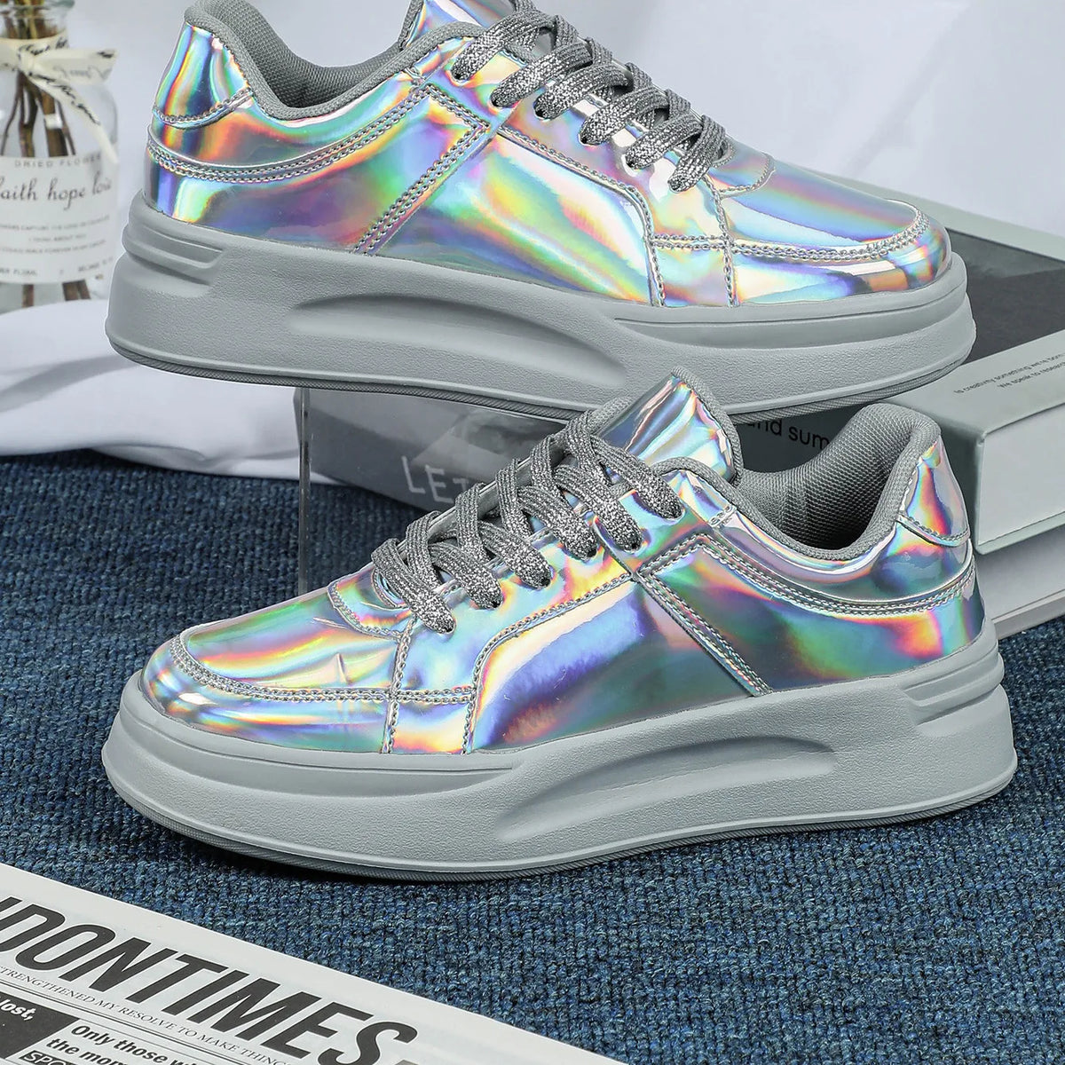 Holographic casual sneakers with thick gray soles, gray laces, and padded collars.