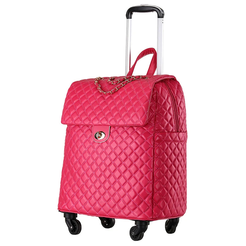 Hot pink quilted PU leather rolling suitcase with gold-tone twist lock, chain accent, and retractable handle.
