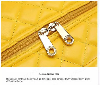 Yellow quilted PU suitcase with gold dual zippers and metallic pull tabs.