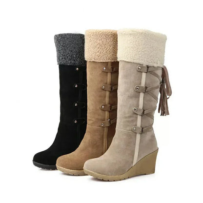 Three knee-high wedge boots in black, tan, and beige suede, featuring faux-shearling cuffs, side straps, and tassels.